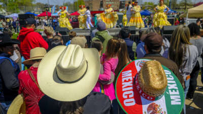 People watch a "Baile Folklorico" dance during the Cinco de Mayo parade in Saint Paul, Minnesota, on May 2, 2026. The Mexican community in the Minneapolis-Saint Paul area is celebrating its first Cinco de Mayo since Immigration and Customs Enforcement (ICE) conducted large operations in early 2026.