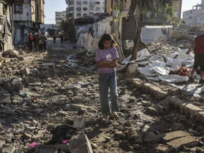 A Palestinian girl walks through the site of an overnight Israeli military strike on structures and tents housing displaced families, killing 10 Palestinians, in Gaza City, on May 28, 2026.