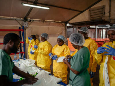 Health care workers put on personal protective equipment before going to examine patients at the Ebola Treatment Center in Munigi, Democratic Republic of the Congo, on June 2, 2026.
