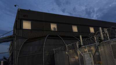 As part of a nightly tradition, imprisoned immigrants greet immigration activists from windows as ICE agents and pro-immigration activists face off outside the Delaney Hall Immigration Detention Center on May 27, 2026, in Newark, New Jersey.