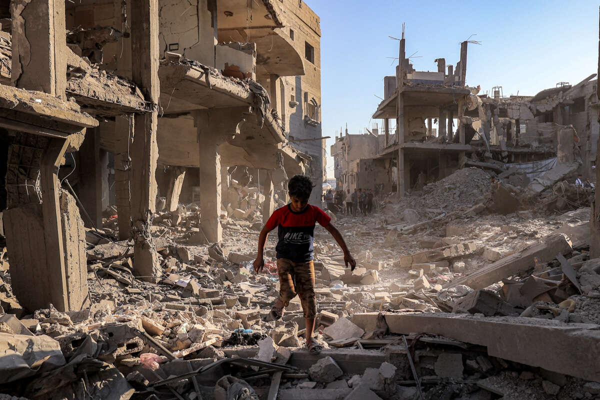 A boy walks through the rubble of a building that was destroyed following Israeli bombardment at the Maghazi camp for Palestinian refugees in the central Gaza Strip, on June 12, 2026.