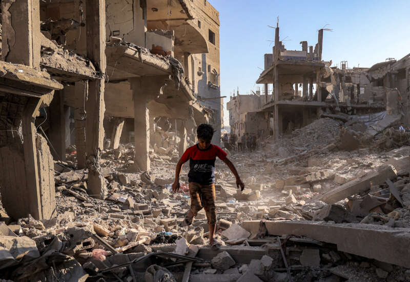 A boy walks through the rubble of a building that was destroyed following Israeli bombardment at the Maghazi camp for Palestinian refugees in the central Gaza Strip, on June 12, 2026.