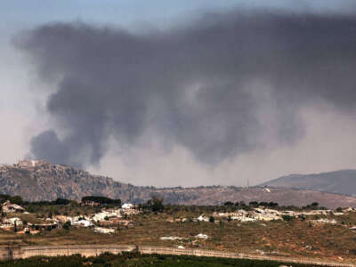 Destroyed buildings and smoke billowing in the distance behind the medieval Beaufort Castle in southern Lebanon, known locally as Qalaat al-Shaqif or Shaqif Arnoun, on June 17, 2026.