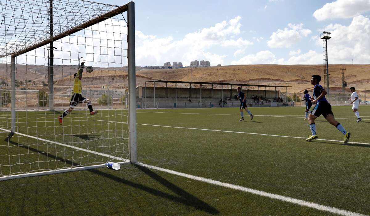 The Beitar Maale Adumim football club team plays against the Ironi Modiin football club during an Israeli league match at the Maale Adumim stadium in the West Bank settlement of Maale Adumin on September 23, 2016. FIFA has been condoning football matches played on stolen land in the occupied West Bank, Human Rights Watch said, calling for Israeli clubs based in settlements to be forced to relocate.