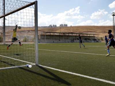 The Beitar Maale Adumim football club team plays against the Ironi Modiin football club during an Israeli league match at the Maale Adumim stadium in the West Bank settlement of Maale Adumin on September 23, 2016. FIFA has been condoning football matches played on stolen land in the occupied West Bank, Human Rights Watch said, calling for Israeli clubs based in settlements to be forced to relocate.