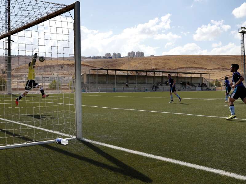 The Beitar Maale Adumim football club team plays against the Ironi Modiin football club during an Israeli league match at the Maale Adumim stadium in the West Bank settlement of Maale Adumin on September 23, 2016. FIFA has been condoning football matches played on stolen land in the occupied West Bank, Human Rights Watch said, calling for Israeli clubs based in settlements to be forced to relocate.