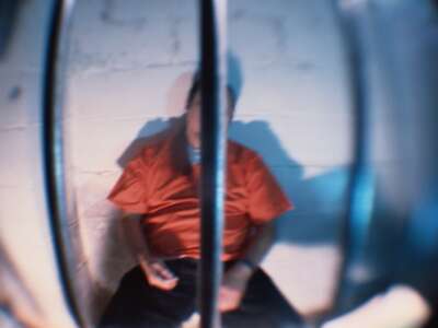Prisoner Behind Bars of Cell