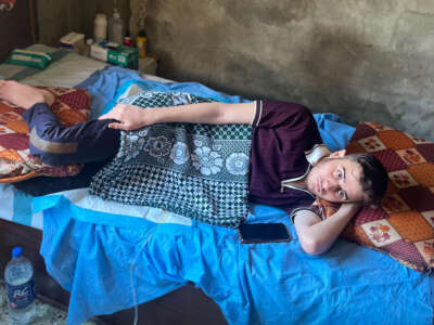 Mohammed Afaneh lying in bed, unable to move.