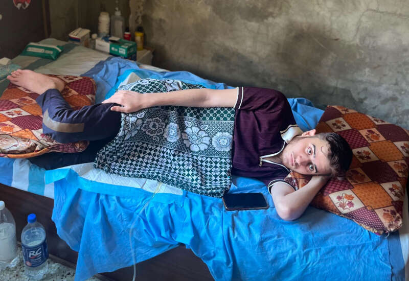 Mohammed Afaneh lying in bed, unable to move.