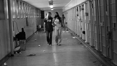 Men Against Sexism member Ed Mead walks with his lover, Danny Atteberry, through the Intensive Security Unit at Walla Walla State Penitentiary in the late 1970s during the one hour a day when they were allowed out of their cells.