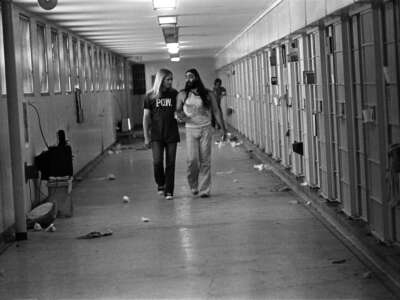 Men Against Sexism member Ed Mead walks with his lover, Danny Atteberry, through the Intensive Security Unit at Walla Walla State Penitentiary in the late 1970s during the one hour a day when they were allowed out of their cells.