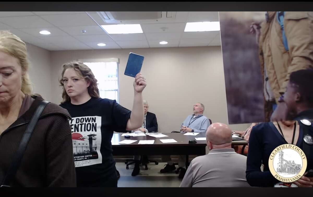 Bobbi Erickson, with the Shut Down Detention Coalition, turns her back on Clearfield County Commissioners who refuse to let her and others from outside counties speak during the public comment portion of a May 26 meeting about why they should vote to cancel their contract with ICE and GEO Group for the Moshannon Valley Processing Center.