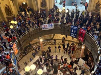 Illinois Revenue Alliance members flood the Illinois State Capitol Rotunda and drop PowerUp banners while legislators are in session on May 27, 2026.