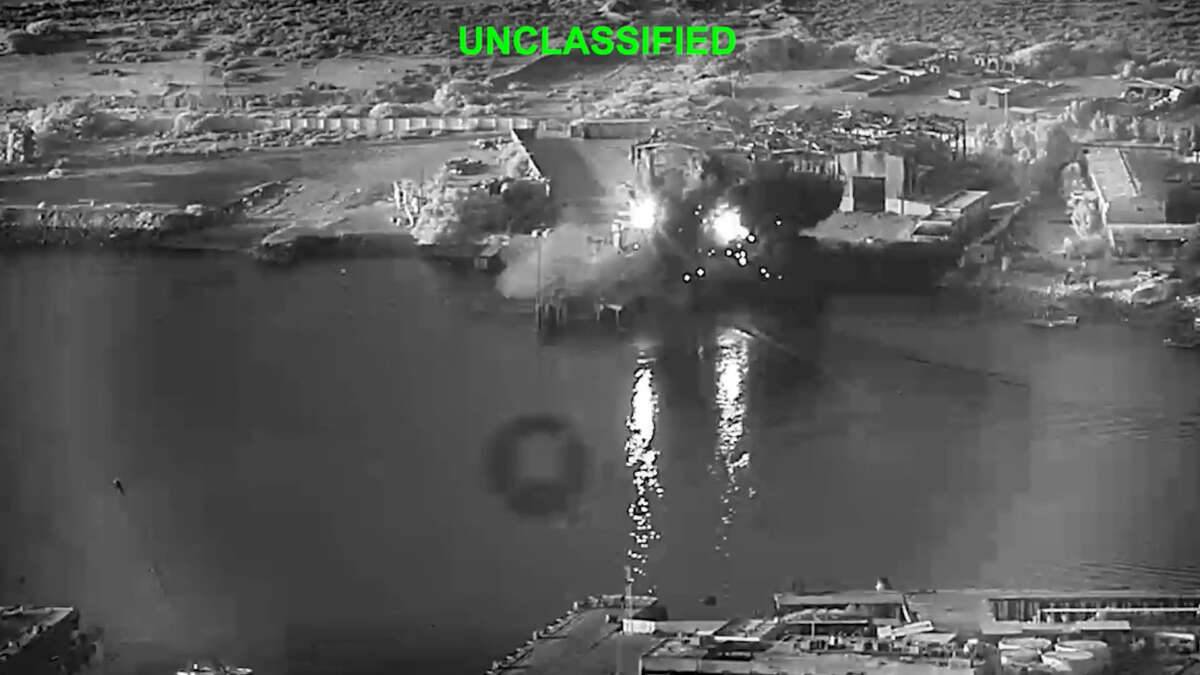 In this handout footage provided by the U.S Department of Defense, U.S. sea drones strike a submarine and a ship maintenance facility on July 13, 2026 in an undisclosed area of Iran.