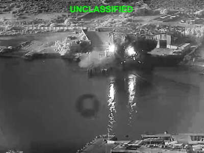 In this handout footage provided by the U.S Department of Defense, U.S. sea drones strike a submarine and a ship maintenance facility on July 13, 2026 in an undisclosed area of Iran.