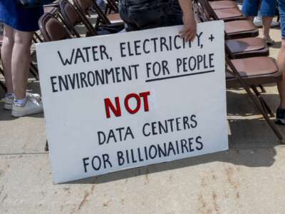 A sign at the "Mother Earth Vs Big Tech" rally in St. Paul, Minnesota on June 26, 2026. The rally was organized based on a petition advocating for a two-year moratorium on the construction of hyperscaled data centers.
