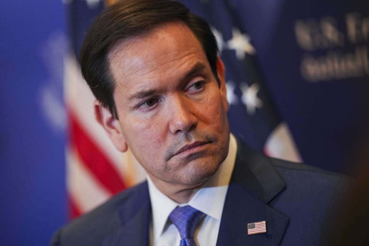 U.S. Secretary of State Marco Rubio looks over as he speaks with members of the media before departing from Bahrain International Airport after his visit to the Middle East.