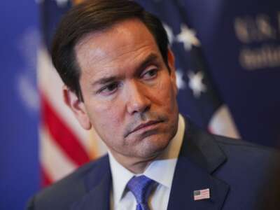U.S. Secretary of State Marco Rubio looks over as he speaks with members of the media before departing from Bahrain International Airport after his visit to the Middle East.
