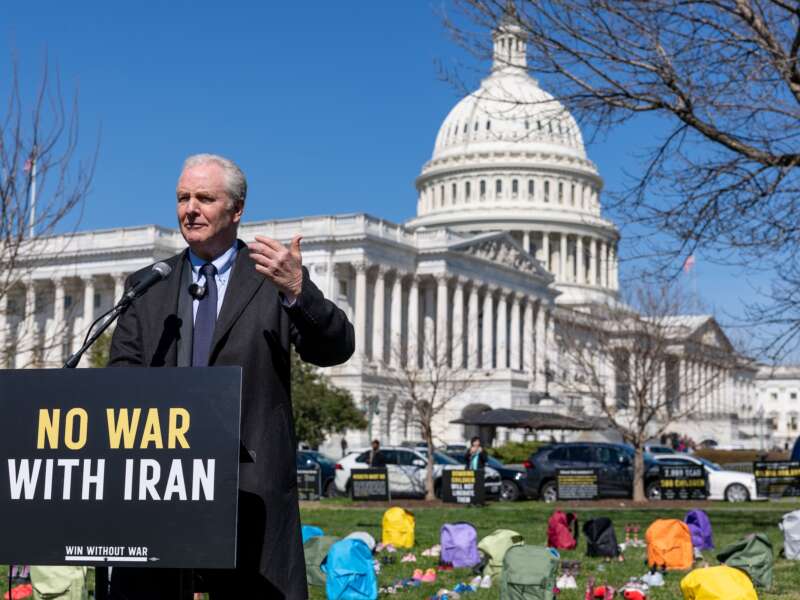 Sen. Chris Van Hollen (D-Maryland) speaks on Capitol Grounds in front of a memorial of 168 pairs of shoes representing those killed in the U.S. strike on an Iranian school, on March 18, 2026 in Washington, D.C.