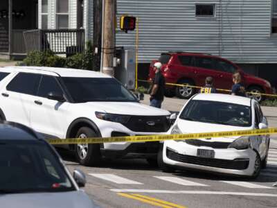 A Kia sedan reportedly driven by the victim of a fatal shooting can be seen with four bullet holes in the windshield at the scene on Pool Street in Biddeford on Monday, July 13, 2026.