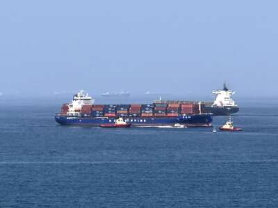 A cargo ship is pictured off coast of the Khor Fakkan Container Terminal along the Gulf of Oman on June 28, 2026.