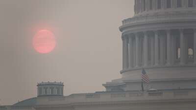 The sun rises behind the U.S. Capitol building during a summer heat wave as smoke from wildfires in Canada fills the air on July 17, 2026 in Washington, D.C.