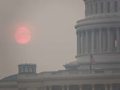 The sun rises behind the U.S. Capitol building during a summer heat wave as smoke from wildfires in Canada fills the air on July 17, 2026 in Washington, D.C.