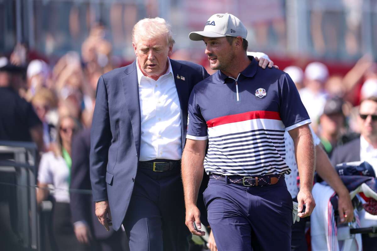 President Donald Trump speaks with Bryson DeChambeau of Team United States on the first tee during the 2025 Ryder Cup at Black Course at Bethpage State Park Golf Course on September 26, 2025 in Farmingdale, New York.