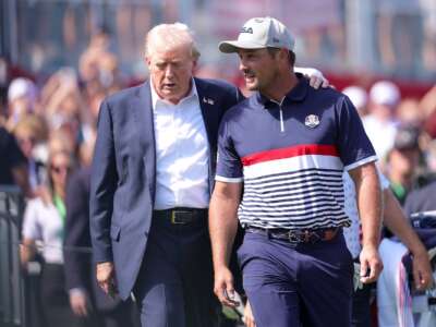 President Donald Trump speaks with Bryson DeChambeau of Team United States on the first tee during the 2025 Ryder Cup at Black Course at Bethpage State Park Golf Course on September 26, 2025 in Farmingdale, New York.