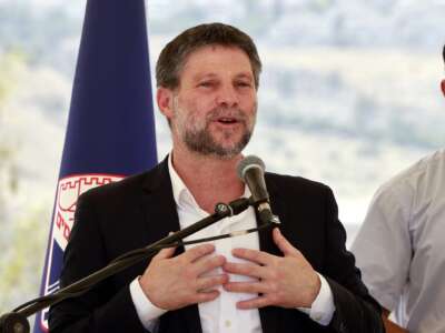 Israeli far-right Finance Minister Bezalel Smotrich speaks during a a press conference near the illegal settlement of Maale Adumim, outside Jerusalem in the occupied West Bank, on August 14, 2025.
