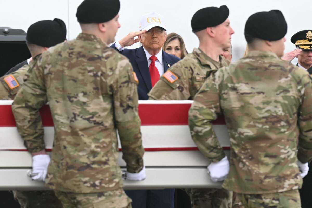 President Donald Trump salutes as members of a U.S. Army team carry a flag-draped transfer case containing the remains of Sgt. 1st Class Noah L. Tietjens during a dignified transfer solemn event at Dover Air Force Base, in Dover, Delaware, on March 7, 2026.