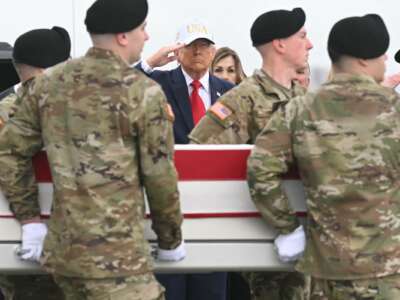 President Donald Trump salutes as members of a U.S. Army team carry a flag-draped transfer case containing the remains of Sgt. 1st Class Noah L. Tietjens during a dignified transfer solemn event at Dover Air Force Base, in Dover, Delaware, on March 7, 2026.