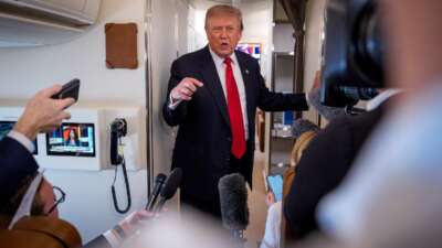U.S. President Donald Trump speaks while aboard Air Force One for a trip to Michigan on July 27, 2026 in flight.