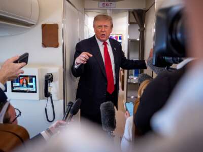 U.S. President Donald Trump speaks while aboard Air Force One for a trip to Michigan on July 27, 2026 in flight.