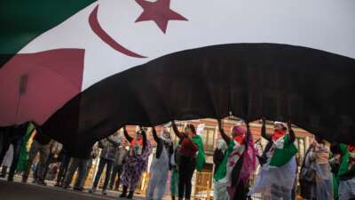 Saharawi women in exile wave a huge flag of Western Sahara during a demonstration calling for the end of the Moroccan occupation and the independence of Western Sahara, in Madrid, Spain, on November 17, 2018.