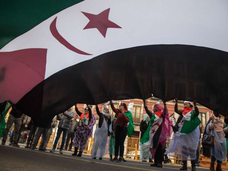 Saharawi women in exile wave a huge flag of Western Sahara during a demonstration calling for the end of the Moroccan occupation and the independence of Western Sahara, in Madrid, Spain, on November 17, 2018.