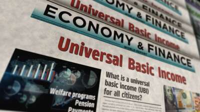 Abstract concept of universal basic income on newspaper printing.