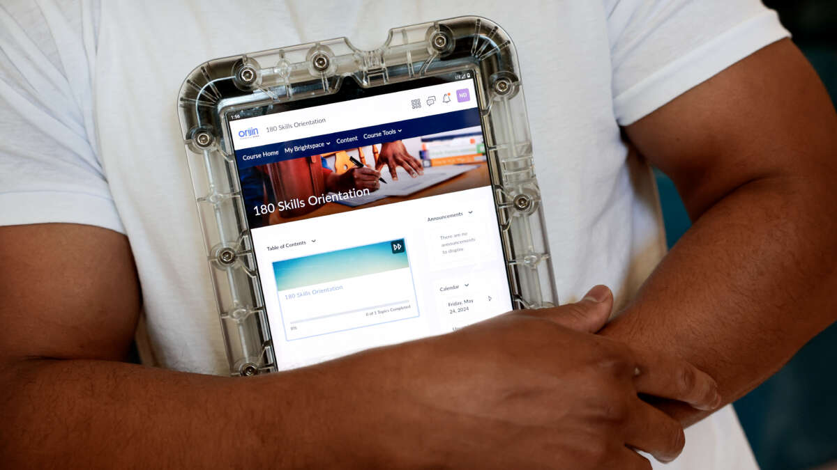 An incarcerated person displays a program and educational tablet supplied by the Department of Corrections at the Massachusetts Correctional Institution in Norfolk, Massachusetts, on May 24, 2024.