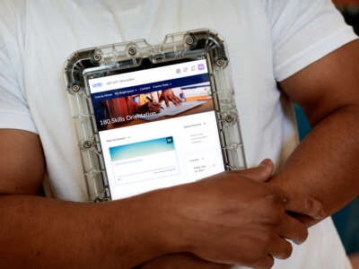 An incarcerated person displays a program and educational tablet supplied by the Department of Corrections at the Massachusetts Correctional Institution in Norfolk, Massachusetts, on May 24, 2024.