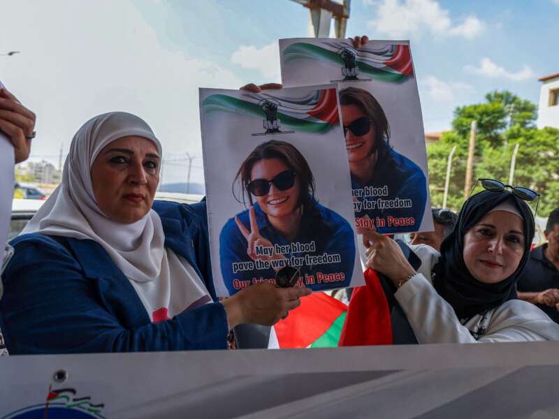 Palestinians and international activists lift portraits of slain Turkish American activist Ayşenur Ezgi Eygi as they arrive for her final farewell at the Rafidia hospital morgue in Nablus in the occupied West Bank, on September 8, 2024.