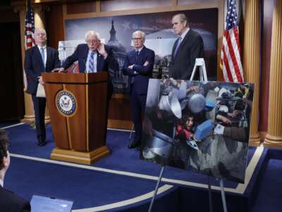 Sen. Bernie Sanders -- joined by fellow Senators Chris Van Hollen, Jeff Merkley, and Peter Welch -- listens to a question at a news conference on restricting arms sales to Israel at the U.S. Capitol on November 19, 2024, in Washington, D.C.