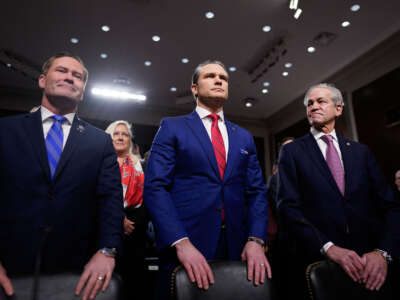 Pete Hegseth appears before the Senate Armed Services Committee for his confirmation hearing with Rep. Michael Waltz, left, and former Sen. Norm Coleman, at Capitol Hill on January 14, 2025, in Washington, D.C.