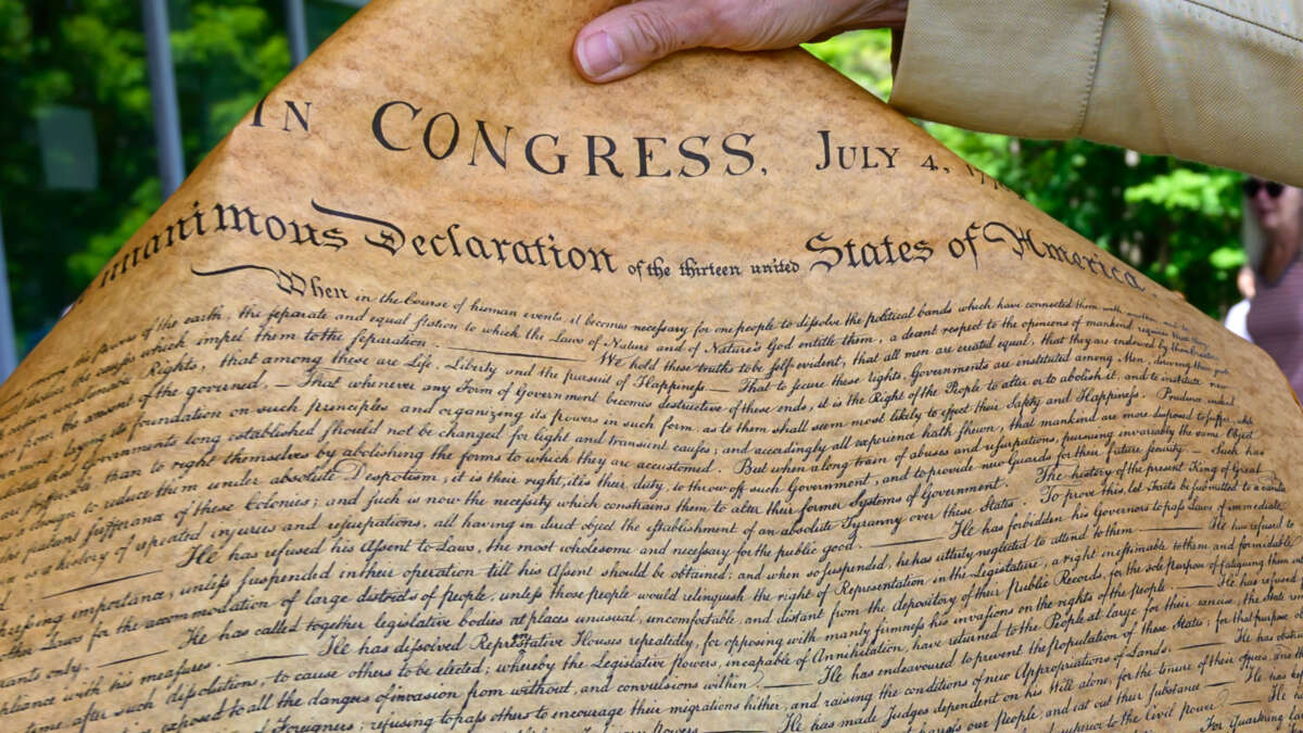 Joe Craig, a park volunteer, holds a copy of the Declaration of Independence on July 4, 2025, at the Saratoga National Historical Park in Stillwater, New York.