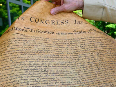 Joe Craig, a park volunteer, holds a copy of the Declaration of Independence on July 4, 2025, at the Saratoga National Historical Park in Stillwater, New York.
