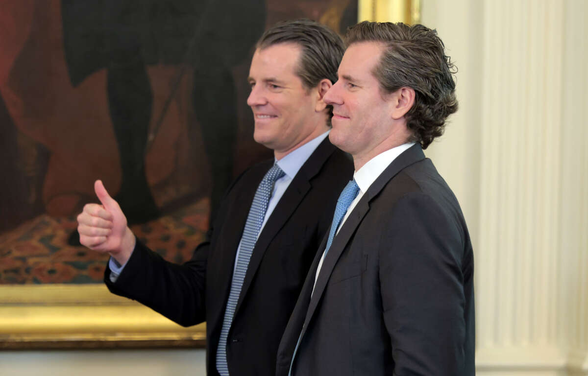 Tyler and Cameron Winklevoss attend the signing ceremony for the “GENIUS Act” in the East Room of the White House on July 18, 2025, in Washington, D.C.