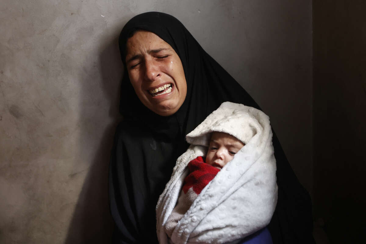 Hiba Abu Jarad, 30, mother of three-month-old Palestinian baby Shatha Abu Jarad, who died of cold weather according to medics, cries while holding Nada, Shatha's twin sister, in Gaza City, Gaza, on January 20, 2026.