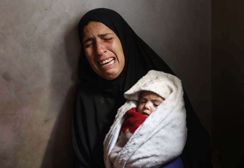 Hiba Abu Jarad, 30, mother of three-month-old Palestinian baby Shatha Abu Jarad, who died of cold weather according to medics, cries while holding Nada, Shatha's twin sister, in Gaza City, Gaza, on January 20, 2026.