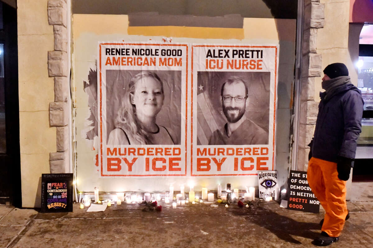 Posters of Renee Nicole Good and Alex Pretti, both US citizens fatally shot by immigration agents, are seen during a candlelight vigil in Minneapolis, Minnesota, on January 28, 2026.