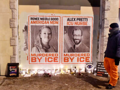 Posters of Renee Nicole Good and Alex Pretti, both US citizens fatally shot by immigration agents, are seen during a candlelight vigil in Minneapolis, Minnesota, on January 28, 2026.