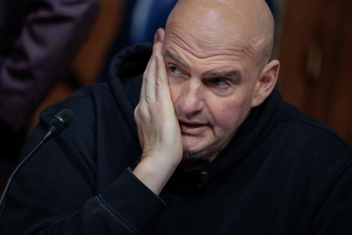 Senate Homeland Security and Governmental Affairs Committee member Sen. John Fetterman prepares to vote to advance Sen. Markwayne Mullin to be Secretary of the Department of Homeland Security during a markup hearing in the Dirksen Senate Office Building on Capitol Hill on March 19, 2026, in Washington, D.C.